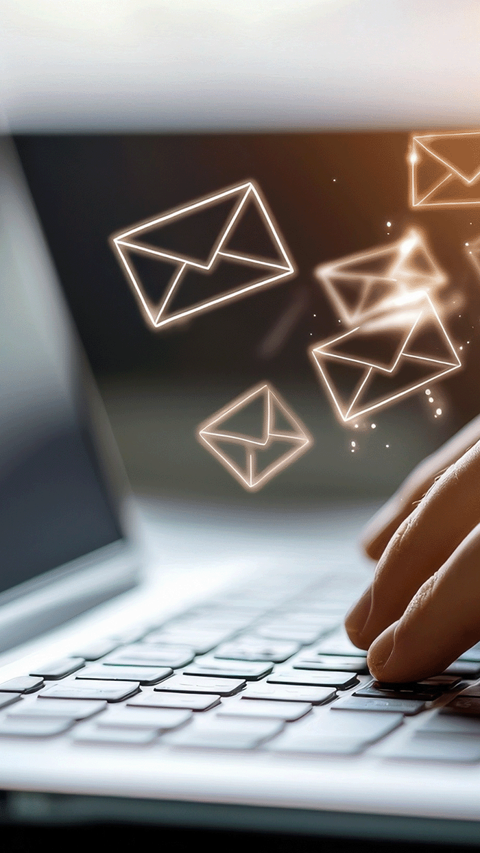 newsletter vis gen sml a keyboard emitting various shining envelope symbols to signify e-newsletters coming from Integrity and Values Leadership Development.