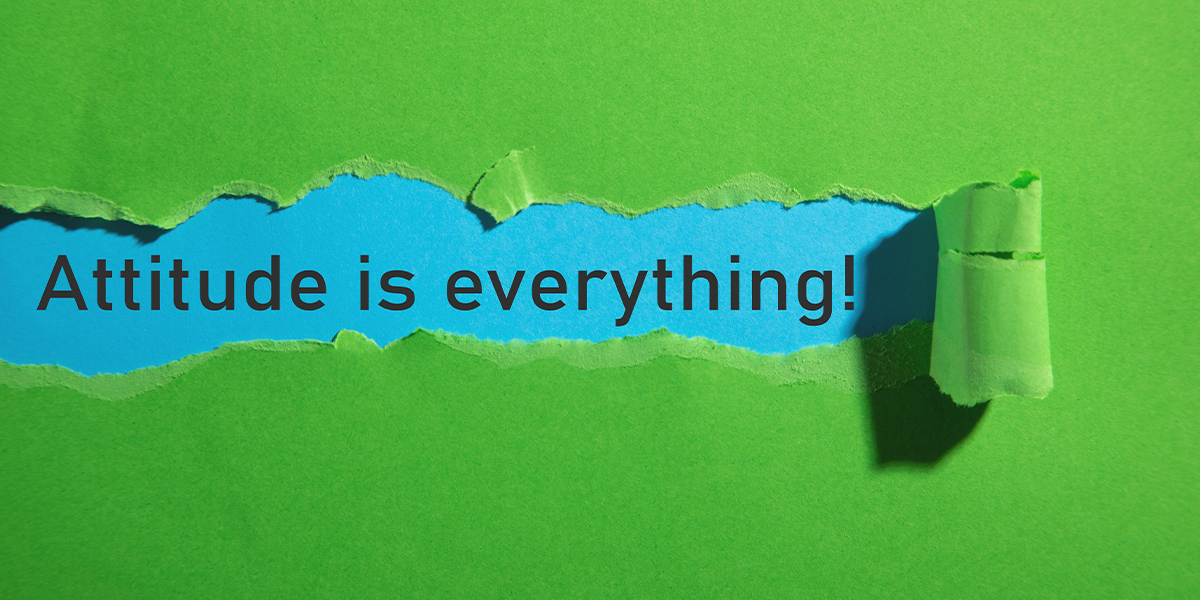 LB_Attitude-Hero-Banner_1200x600_2025-10-21 Illustration of three people assembling puzzle pieces that spell the word ‘empathy.’ One person on the left holds the piece with ‘em,’ a person on a step ladder holds the middle piece with ‘pa,’ and another person on the right holds the piece with ‘thy.’ The background is yellow with a large abstract heart shape behind them, symbolising teamwork and compassion.